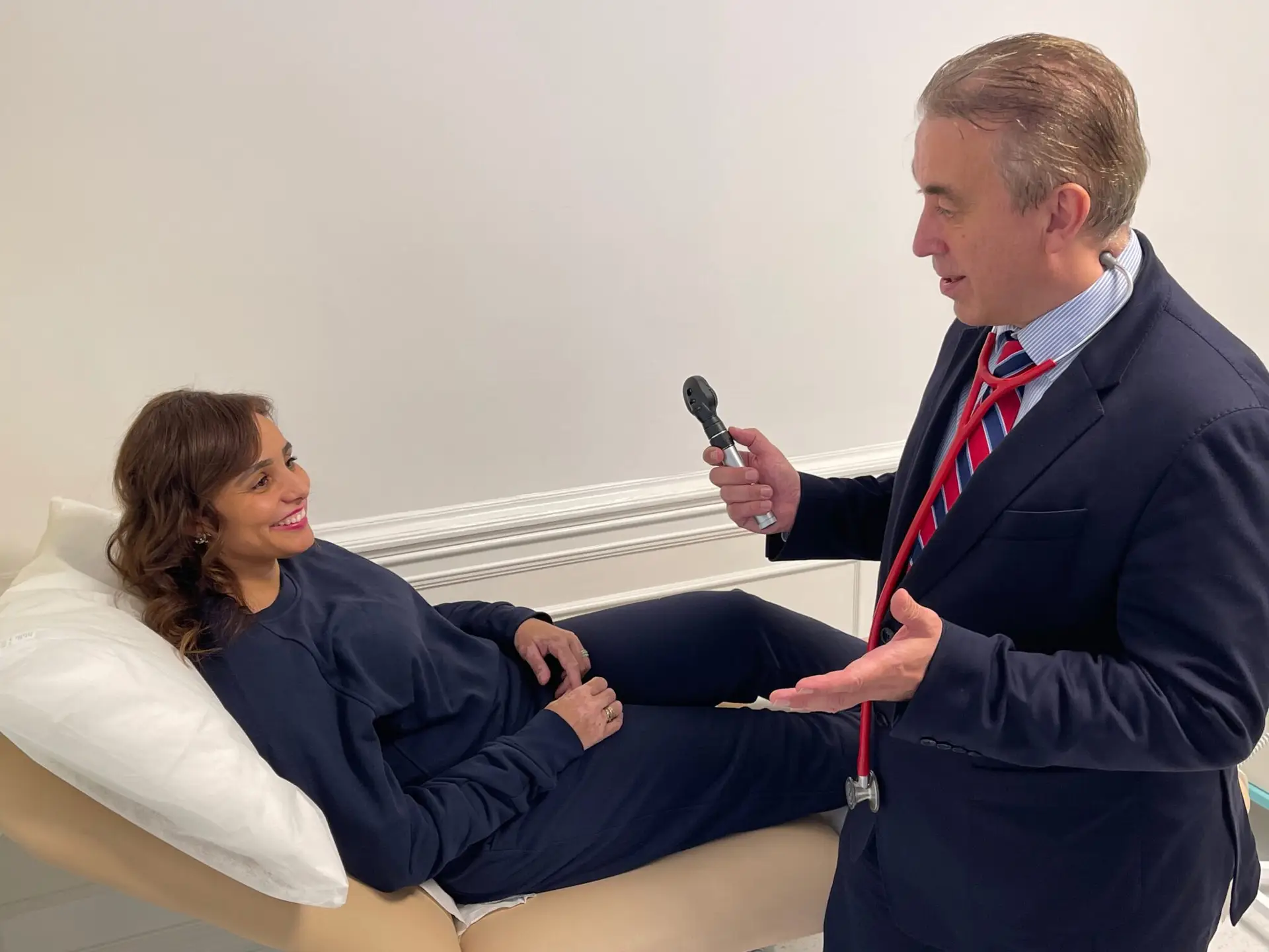 Dr garry savin conducting a consultation with a female patient at Lumen harley street clinic