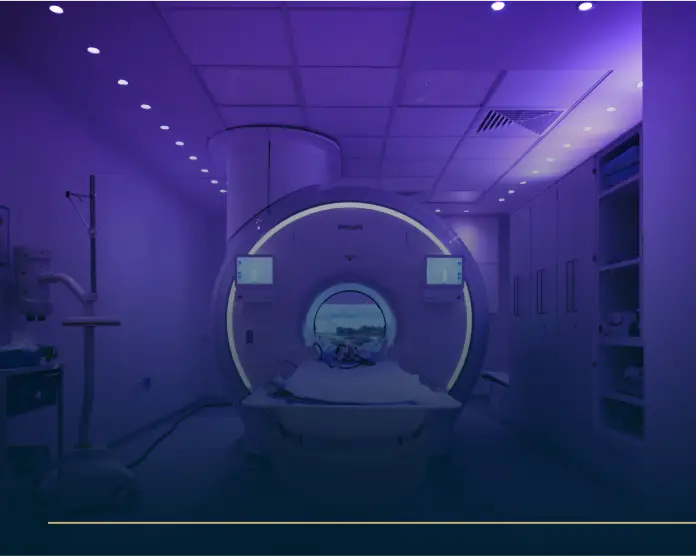 Modern MRI room with ambient purple lighting and machine for cardiac MRI scan