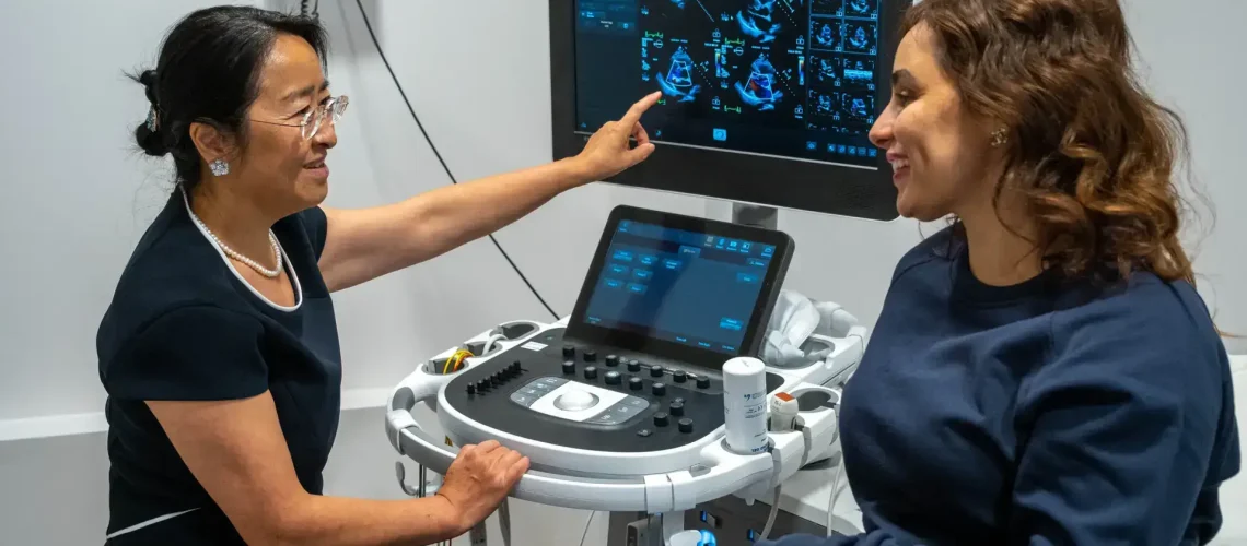 Dr wei li explains ultrasound scan results to a patient